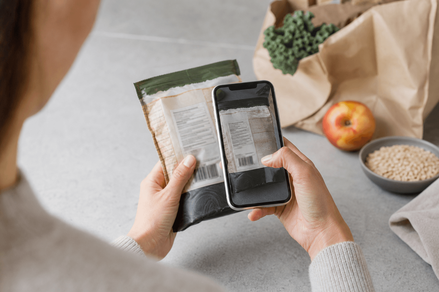 A person scanning the ingredient label on a packaged food with a phone